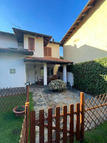 a house with a fence in front of a yard at Villa Mia Lugano Lake in Brusimpiano