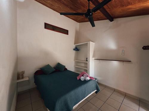 ein Schlafzimmer mit einem grünen Bett in einem Zimmer in der Unterkunft Pacific Buddha in Brisas de Zicatela