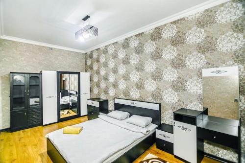 Un dormitorio con una cama grande y una pared en Apartment Armani Lux en Bakú