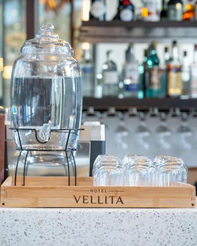 a glass cloche on a wooden stand on a table at Hotel Vellita Siem reap in Siem Reap