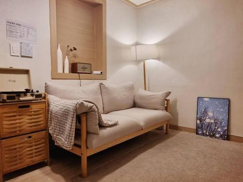a living room with a couch and a dresser at Seoul National University Apartment in Seoul