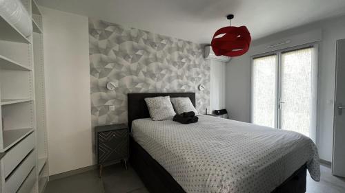 a bedroom with a bed and a wall with triangles at SWEET HOME in Taverny