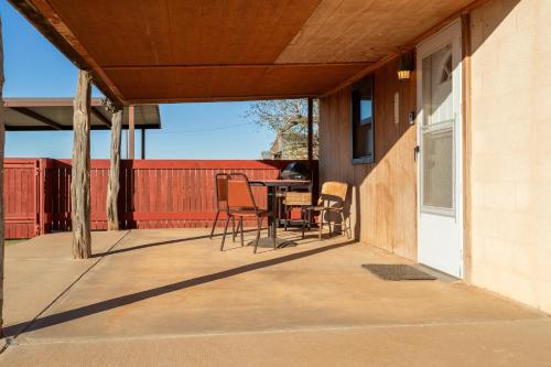 a patio with chairs and a table on a house at The Quaint Country Home in Brownfield