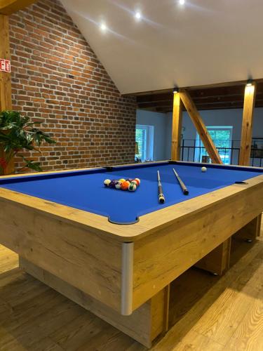 a blue pool table with billards on top of it at Na Uboczu in Gryfów Śląski