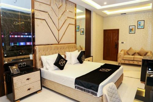 a hotel room with a bed and a television at The Signature Hotel in Islamabad