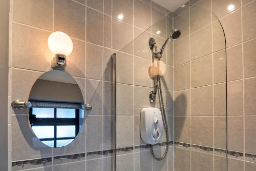 a bathroom with a shower and a mirror at Finest Retreats - The Lodge at The Cridford Inn in Trusham