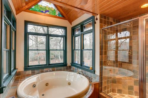 a bathroom with a tub and a shower and windows at Lakefront Custom-Built Mentone Home Game Room! in Mentone