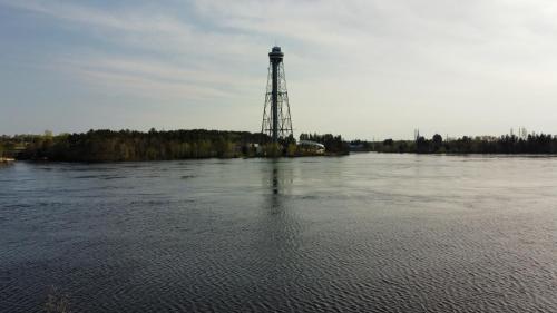 a lighthouse on an island in the middle of a river at Hôtel Énergie Shawinigan in Shawinigan