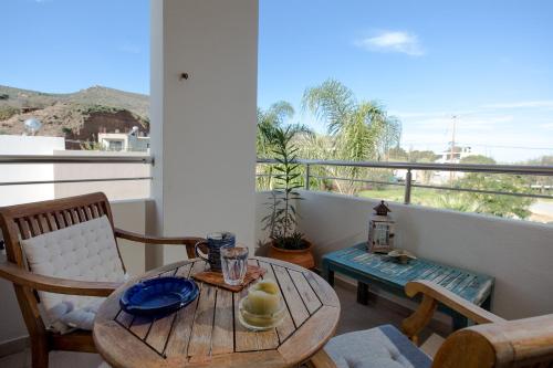 a table and chairs on a balcony with a view at Arodamos Studios & Apts in Kissamos