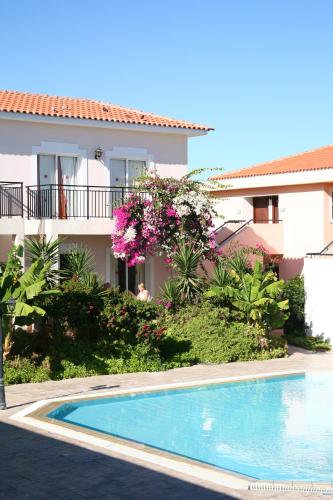 a swimming pool in front of a house at Akamanthea Holiday Village in Polis Chrysochous