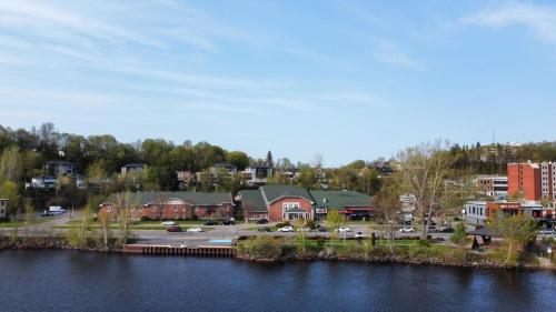 a town next to a body of water with buildings at Hôtel Énergie Shawinigan in Shawinigan