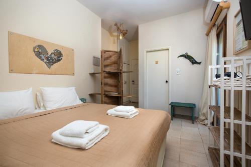 a bedroom with a bed with towels on it at Arodamos Studios & Apts in Kissamos