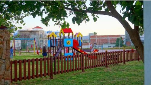 a playground with a slide in a park at Miradore golfe in Martil