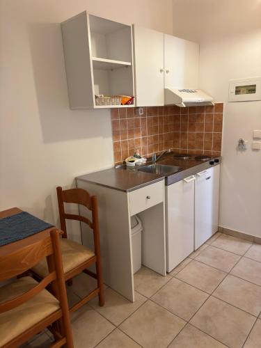a small kitchen with a sink and a refrigerator at Stegna Sea & Sun in Archangelos