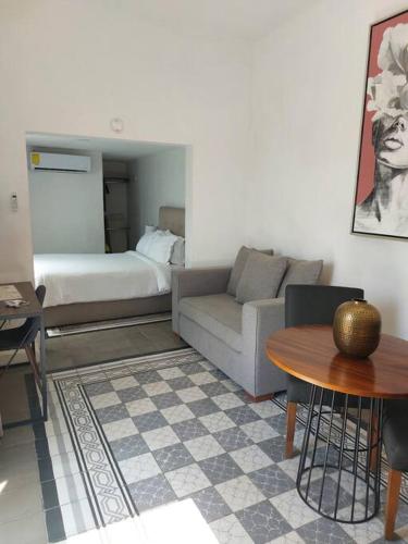 a living room with a couch and a table at Casa Monarcas - Diana (with AC) in Guadalajara
