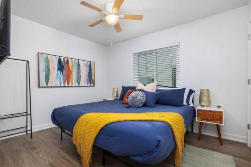 a bedroom with a large blue bed with a ceiling fan at Vulcan’s Hideout / Colorful C2 in Birmingham