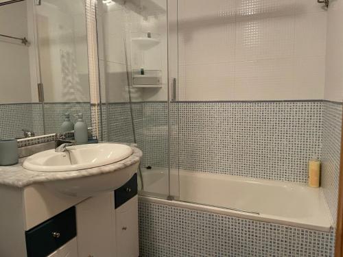 a bathroom with a sink and a shower and a tub at Inmocyma Cerler- Aigualluts-Pirineo en familia in Cerler