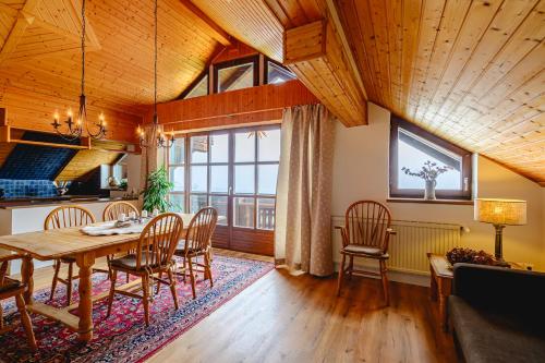 a dining room with a table and chairs at Landhaus BERGSEE in Bodensdorf