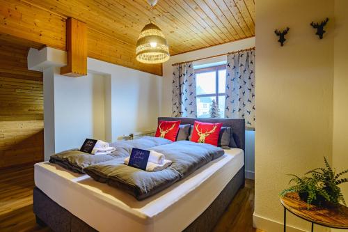 a bedroom with a bed with pillows on it at Landhaus BERGSEE in Bodensdorf