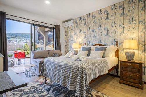 a bedroom with a large bed and a couch at White Rabbit I by Homie in Calheta