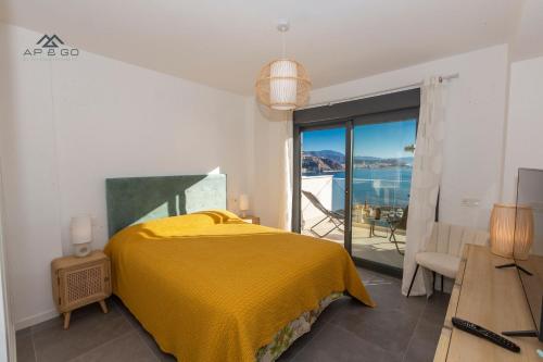 a bedroom with a bed and a view of the ocean at Sky Marina Luxury in La Herradura