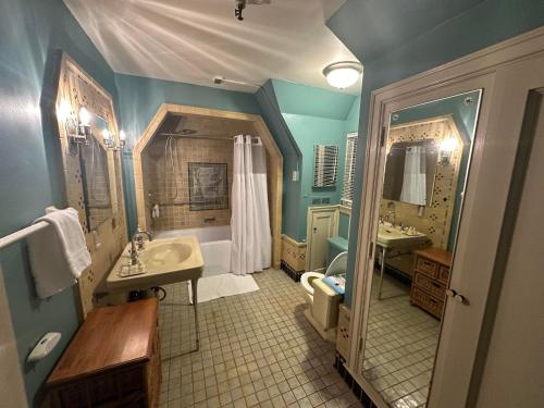 a bathroom with a tub and a sink and a shower at The Oaks B&B Hotel and Spiritual Center in Jamestown