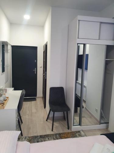 a living room with a chair and a table at Comfort Stay, EV, Parking in Bolesławiec