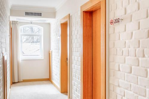 a hallway with a door and a window at Praga Hotel in Tashkent