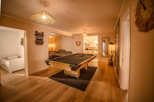 a living room with a pool table in it at Lilie location sud in Petite Île
