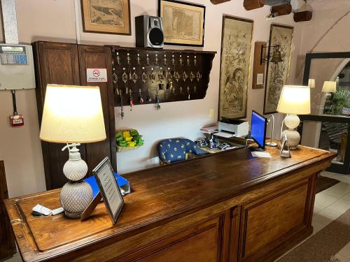 a desk with a lamp and a computer on it at Hotel La Castellana in Paysandú