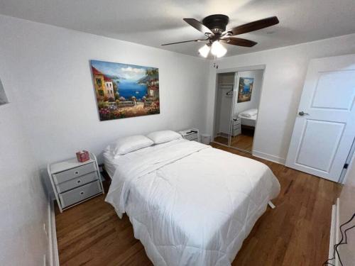a bedroom with a white bed and a ceiling fan at 2 bedroom in Denver, Centralized in Denver