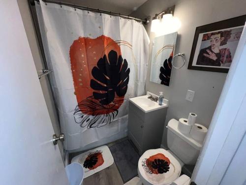 a bathroom with a toilet and a shower curtain at 2 bedroom in Denver, Centralized in Denver