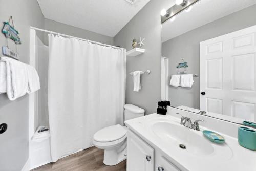biała łazienka z toaletą i umywalką w obiekcie Crystal Village 16B is a 2 Bed 2 bath Condo near the Beach that sleeps 6 w mieście Destin