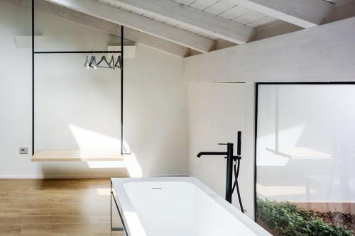 a room with a white table and a window at Via Del Centro Guesthouse in Oristano