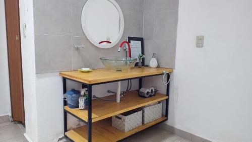 a bathroom with a counter with a sink and a mirror at Monoambiente temporario Banda in La Banda