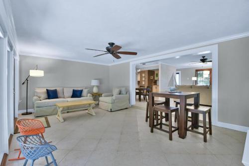 a living room with a couch and a table at Zen Pool Home in Lighthouse Point