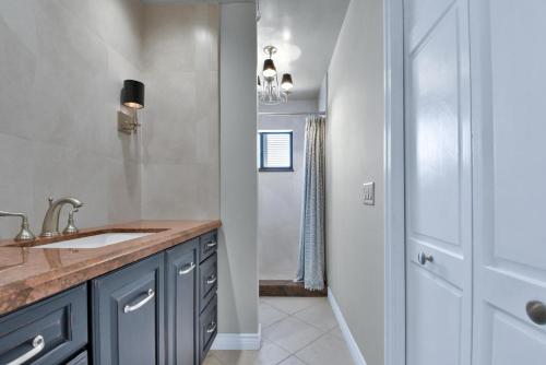 a bathroom with a sink and a shower at Zen Pool Home in Lighthouse Point