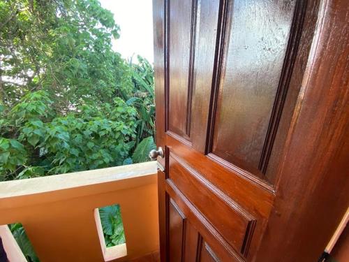 a wooden door in front of a window at Phuket Latika Mansion by Andaman Home in Phuket Town