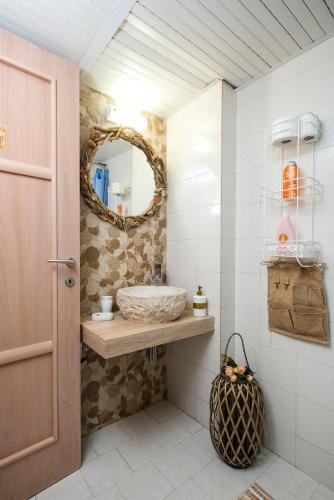 a bathroom with a sink and a mirror at Arodamos Studios & Apts in Kissamos
