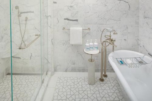 a bathroom with a shower and a tub and a toilet at Keswick Hall in Charlottesville