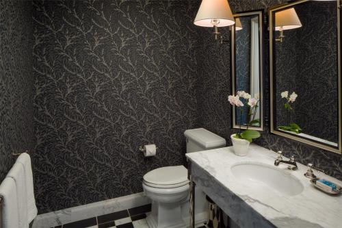 a bathroom with a toilet and a sink at Keswick Hall in Charlottesville