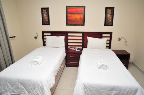 two beds sitting next to each other in a room at Hotel Destiny in Ongwediva