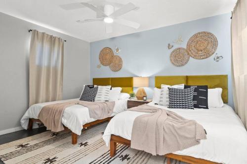 a bedroom with two beds and a ceiling fan at Phoenix Haven - Modern 4BR - Fire pit - Retreat - Golf in Phoenix
