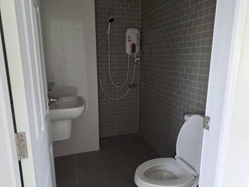 a bathroom with a shower with a toilet and a phone at Phuket House and Home Apartment in Ban Huai Luk (1)