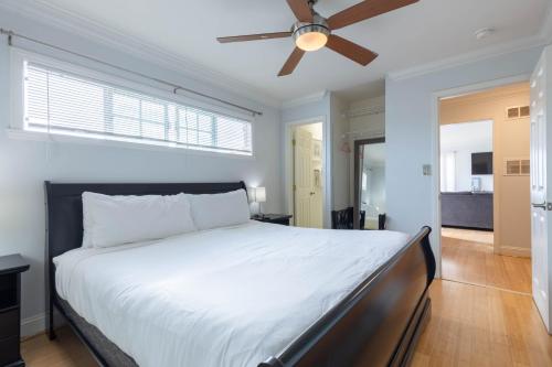 a bedroom with a large bed with a ceiling fan at Ocean View Hideaway Unit #3 in San Clemente