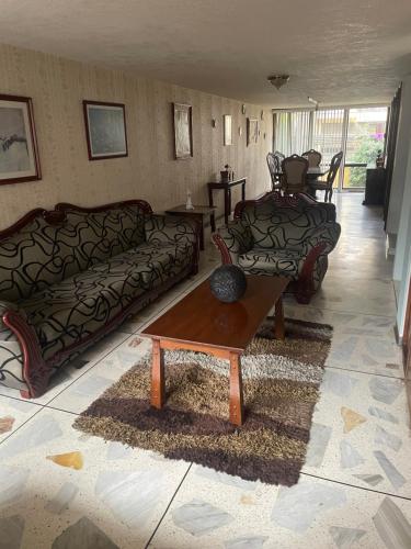 a living room with two couches and a coffee table at Habitación con baño privado exterior in Mexico City