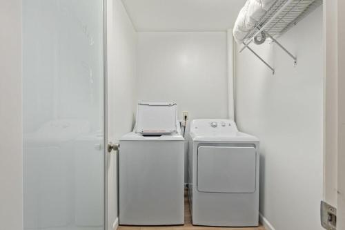a white room with two machines and a stove at New remodeled home on golf course in Mesa