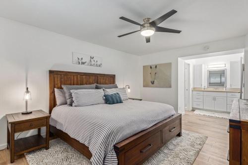 a bedroom with a bed and a ceiling fan at New remodeled home on golf course in Mesa
