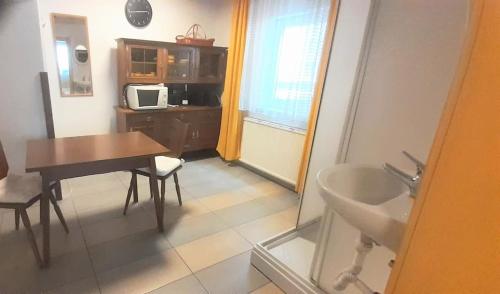 łazienka ze stołem, umywalką i stołem oraz kuchnia w obiekcie Villa Fortuna Natur w mieście Lackenhof
