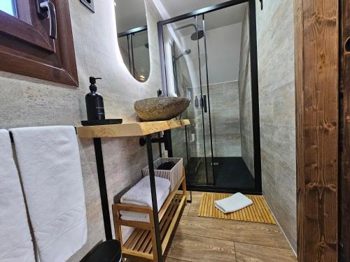 a bathroom with a sink and a shower at Les Flors - Hotel Rural & Cabanyes in Gramós